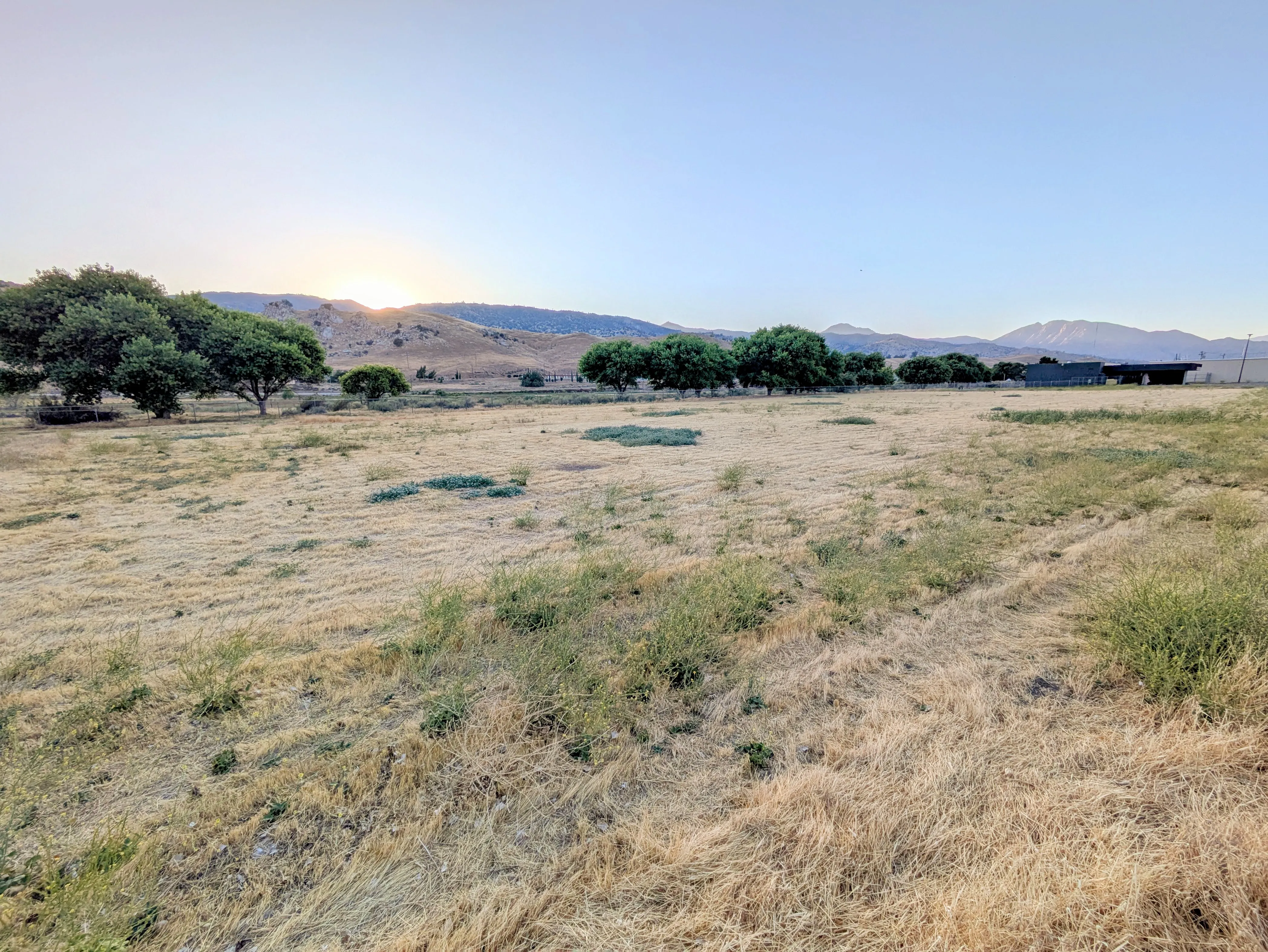 View of the vacant lot with a sunset in the background